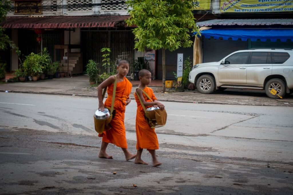 Zwei Novizen beim Almosengang der Mönche in Luang Prabang